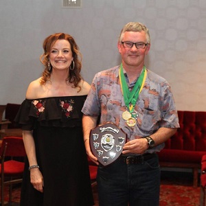 Greg, 2017 men's winner, receiving his shield from Sue.